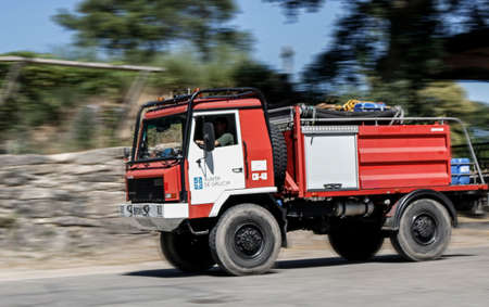 Fire truck is heading quickly towards the wildfireのeditorial素材