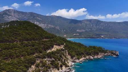 Mountainous Coastline with Blue Sea and Forested Hillsの写真素材