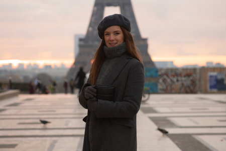 Parisian Woman Enjoying Sunrise at Iconic Eiffel Towerの写真素材