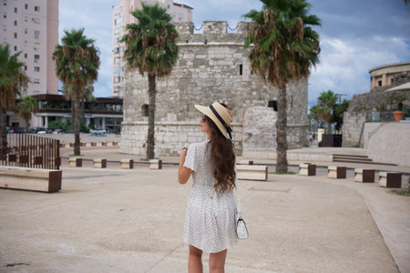 Woman in white dress exploring historic Durres, Albaniaの写真素材