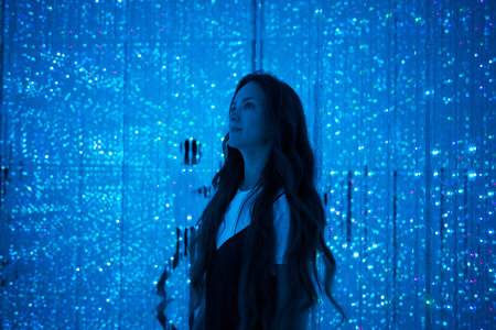Woman Immersed in Blue Digital Light Art at TeamLab Tokyo