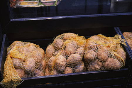 Fresh Potatoes in Mesh Bags at Food Preparation Station