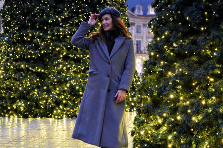 Smiling woman in Paris on Christmas decorated streetの写真素材