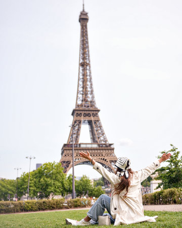 Happy woman celebrating near Eiffel Tower in Parisの写真素材