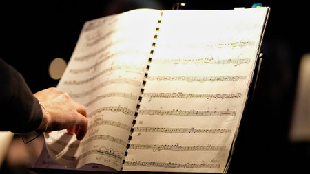 Musician turning music sheet on stageの写真素材