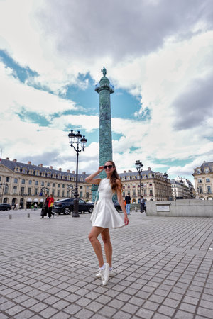 Woman in white dress walking at Place Vendome Paris on July 17 2025のeditorial素材