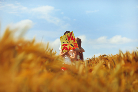 Young couple in love with a kiteの写真素材