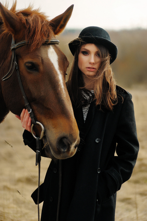 portrait of beautiful girl near to a horseの写真素材