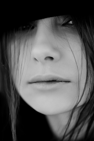 black and white portrait of a girl in a hatの写真素材