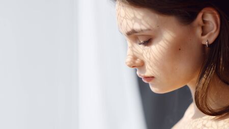 portrait of a girl by the windowの写真素材