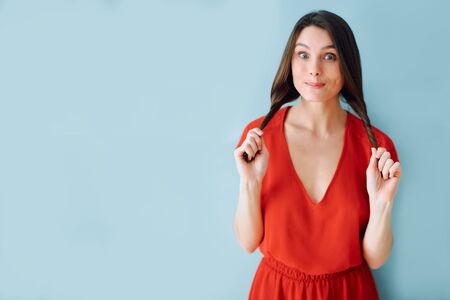 studio portrait of a girl in a red dressの写真素材