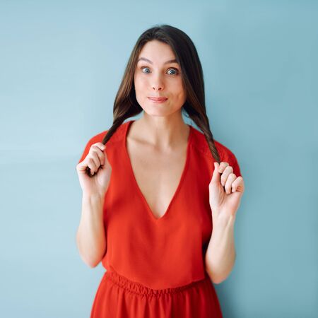 studio portrait of a girl in a red dressの写真素材