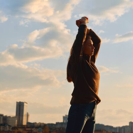 portrait of a young girl on a city backgroundの写真素材