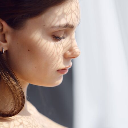 portrait of a girl by the windowの写真素材