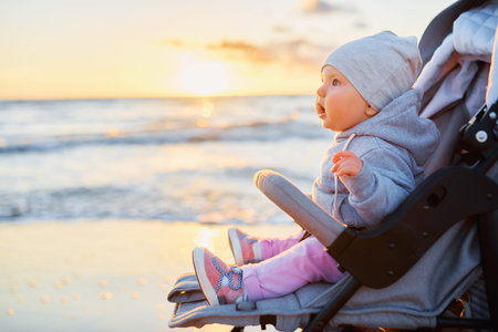 A baby sitting on a beach