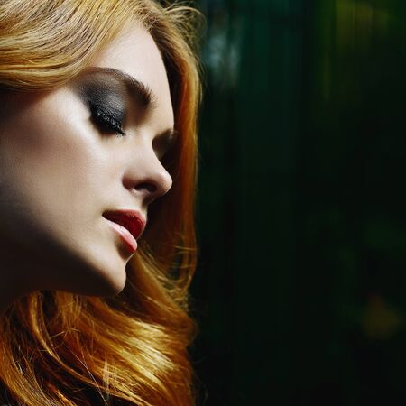 portrait of beautiful girl with ray on sunshine on her faceの写真素材