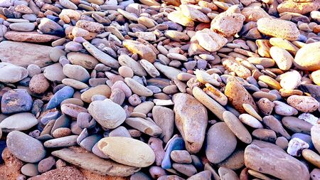 natural pebbles stone, grey gravel beach texture background.の写真素材