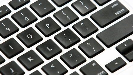 Laptop computer keyboard keys close up, black and white.