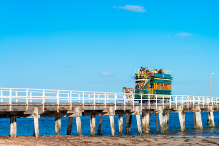 Victor Harbor, South Australia - April 4, 2015: People are riding the horse-drawn carriage from the Granite Island back to the main land. Victor Harbor is one of the most popular tourist attractions in South Australia.のeditorial素材