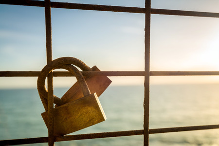 Rusty love locks hanging on the fence as a symbol of loyalty and eternal loveの写真素材