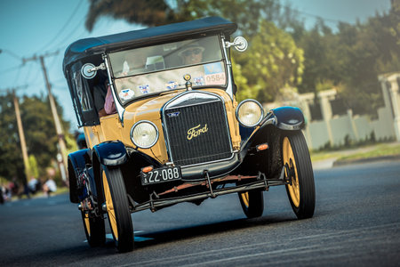 Adelaide, South Australia - September 28, 2014: Old Ford T car with people on board is driving on the street during the Bay to Birdwood car run.のeditorial素材