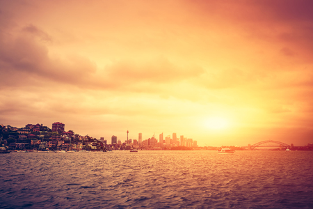 Sydney skyline at sunset with stormy clouds. Cross processing effect appliedの写真素材