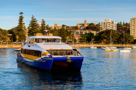 Sydney, Australia - November 10, 2015: Manly Fast Ferry boat at Manly wharf ready to pick up passengers and depart to Sydney Cirqular Quay on a warm sunny evening.のeditorial素材