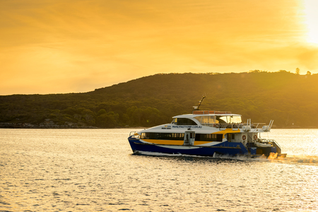Sydney, Australia - November 10, 2015: Manly Fast Ferry boat heading to Sydney Cirqular Quay with passengers onboard on a warm sunny evening.のeditorial素材