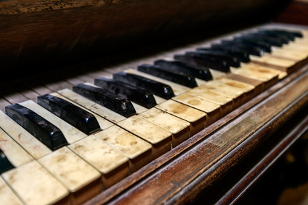 Dirty dusty antique piano in shed. Shallow DOFの写真素材