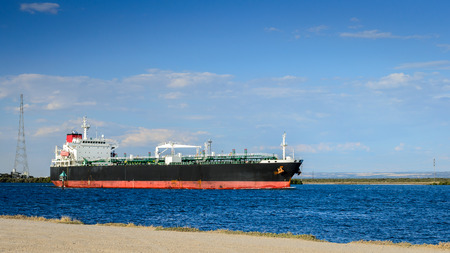 Oil products tanker heading to the port through canalの写真素材