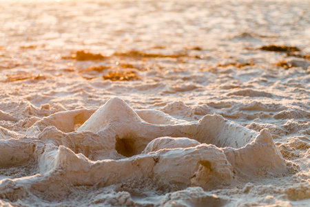 Sand castle on the beach at sunset, South Australia. Color-toning applied