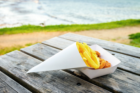 Traditional australian calamari rings with chips take away on the table at Port Elliot beach, South Australiaの写真素材