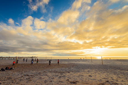 Adelaide, Australia - August 16, 2015: People playing volleyball at Glenelg Beach on a warm sunny eveningのeditorial素材