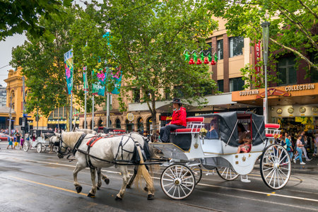 Melbourne, Australia - December 27, 2016: Horse drawn carriages with tourists departing from Flinders Street station opposite Federation Square.のeditorial素材