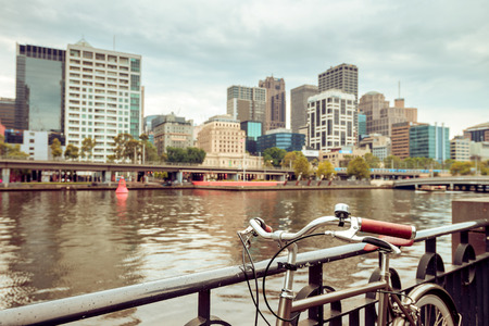 Vintage style bicycle in parked in Melbourne CBD near the Yarra riverの写真素材