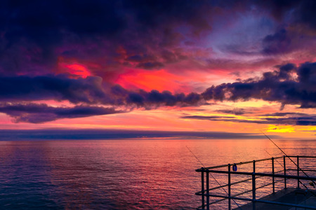 Colorful dramatic sunset view above Glenelg Beach viewed from jetty, South Australiaの写真素材