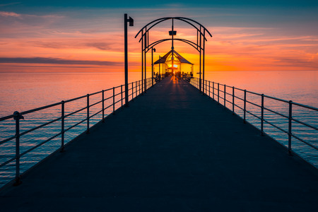 People walking along Brighton Jetty at sunsetの写真素材