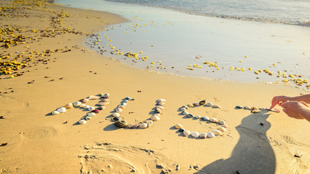 Australia word drawn using shells on sand at the beachの写真素材
