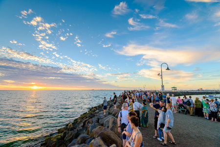 Melbourne, Australia - December 28, 2016: Crowd of people gathered at St Kilda breakwater to watch penguins after sunset on a warm summer eveningのeditorial素材