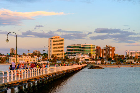 Melbourne, Australia - December 28, 2016: People walking along St. Kilda Beach jetty at sunset on a hot summer dayのeditorial素材