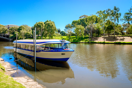 Tourists boat in Adelaide city anchored near King William road in  Torrens river on a bright dayの写真素材