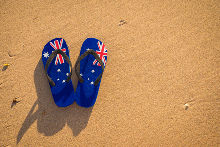 Thongs with Australian flag on the beach at sunsetの写真素材
