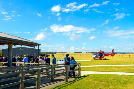 Princetown, Victoria, Australia - December 30, 2016: People queued up in line for scenic 12 Apostles Helicopters ride above Bay of Islands via London Bridge on a bright day.のeditorial素材