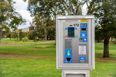 Adelaide, Australia - August 27, 2017: Parking meter  installed near St. Peter's Cathedral in Adelaide CBD with cars parked along the streetのeditorial素材