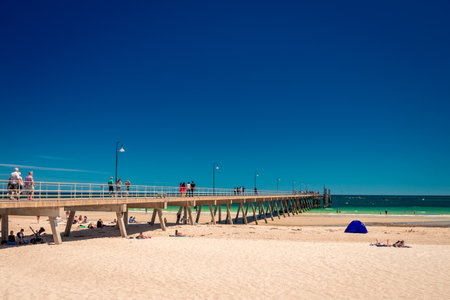 Glenelg, South Australia - February 28, 2016: People  relaxing at Glenelg beach on a bright summer day viewed from Moseley Squareのeditorial素材