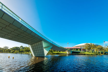 Adelaide, Australia - January 13, 2017: Iconic Torrens foot bridge with Adelaide Oval  viewed across...