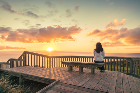 Woman looking at  sunset at Hallett Cove boardwalk in South Australiaの写真素材