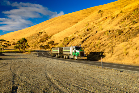 Adelaide, South Australia - January 24, 2016: Modern australian commercial truck driving down the road at sunset near Mypongaのeditorial素材