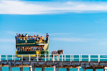 Victor Harbor, South Australia - December 3, 2016: People riding Victor Harbor Horse Drawn Tram from the Granite Island to the main land. This sight attracts many tourists all year around from all over the world.のeditorial素材