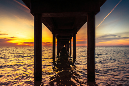 Dramatic sunset view from under Brighton Jetty, South Australiaの写真素材